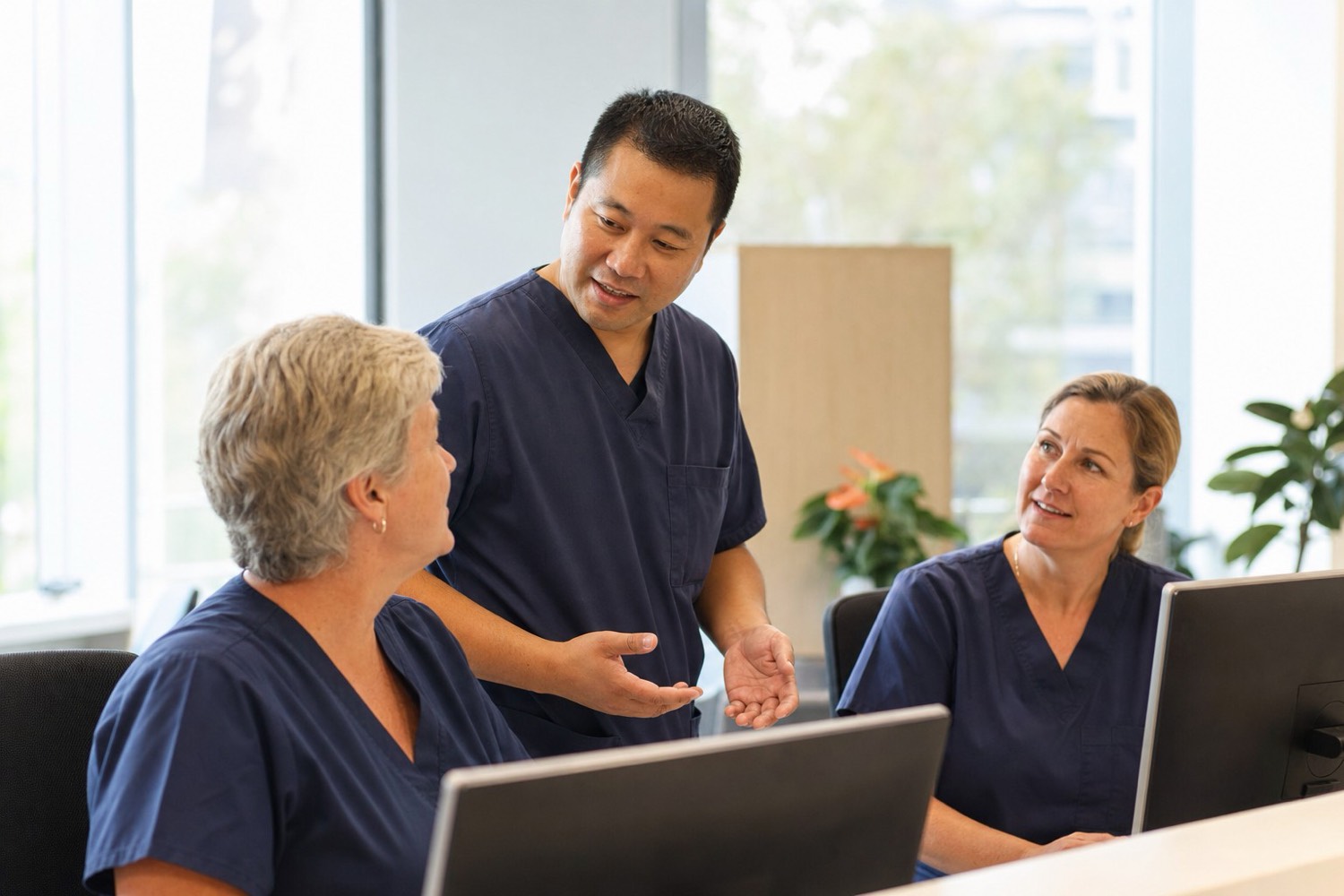 Staff reviewing information together at a workstation